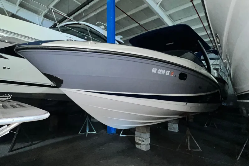Slide: The Image of 2017 Sea Ray 280 SLX boat in storage, side view. - 2