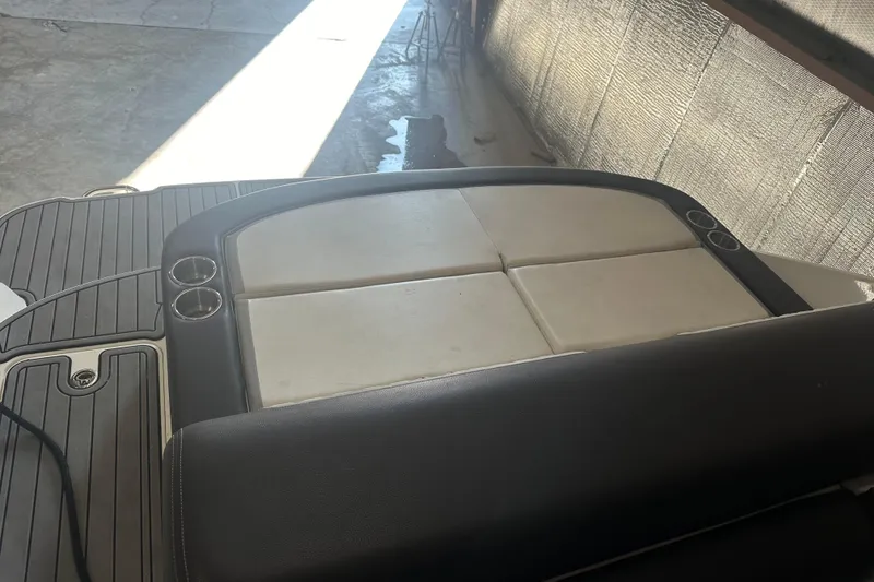 Slide: The Image of 2017 Sea Ray 280 SLX boat interior with cushioned seating and cup holders. - 21