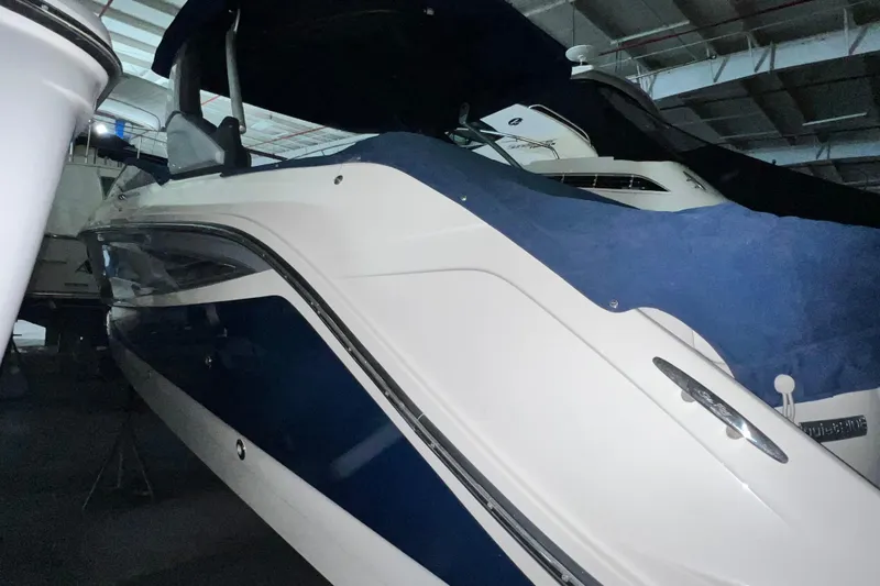 Slide: The Image of 2017 Sea Ray 280 SLX boat in storage, covered with a blue tarp. - 5