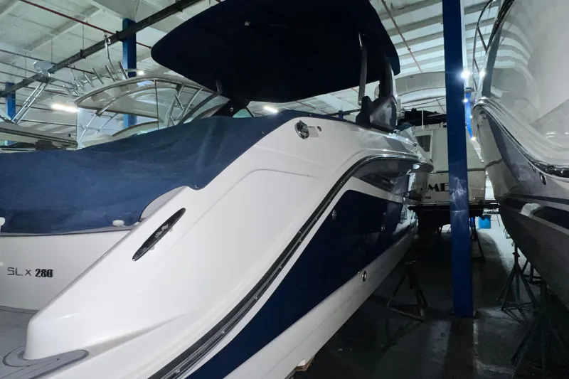 Slide: The Image of 2017 Sea Ray 280 SLX boat in indoor storage, side view. - 6