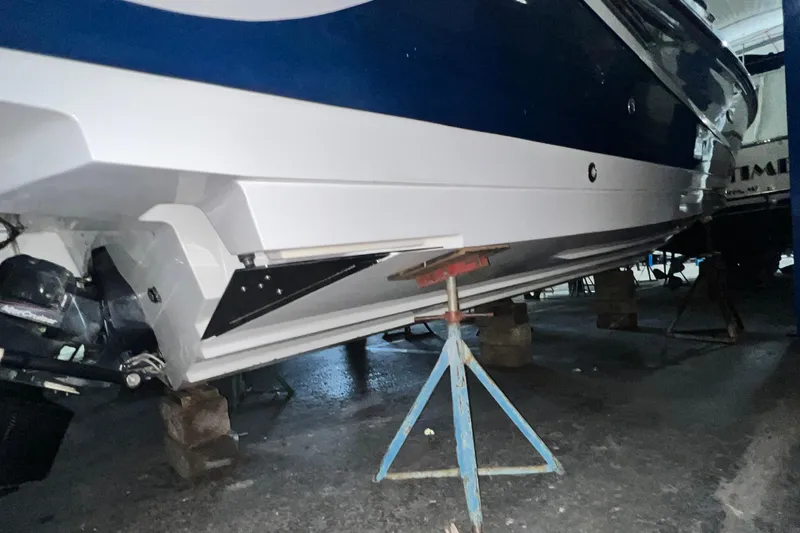 Slide: The Image of 2017 Sea Ray 280 SLX boat on stands in a garage. - 7