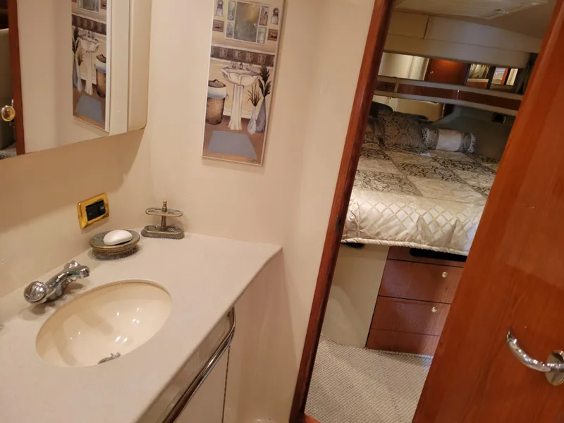 Slide: The Image of 2001 Sea Ray 450 Express Bridge interior with bathroom and bedroom view. - 19