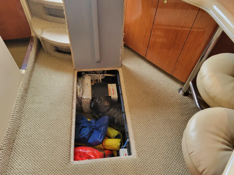 Slide: The Image of 2001 Sea Ray 450 Express Bridge interior storage compartment with equipment and supplies. - 30