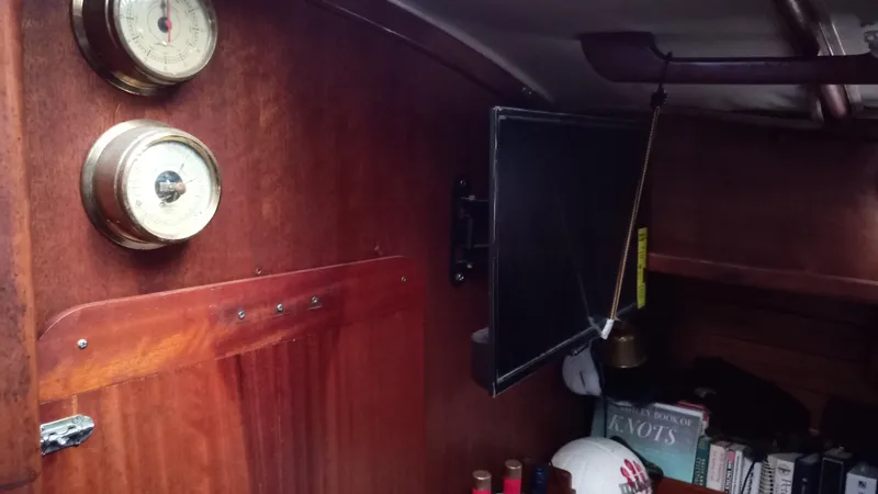 Slide: The Image of Interior of a 1977 Ericson 31 yacht with wood paneling and gauges. - 11
