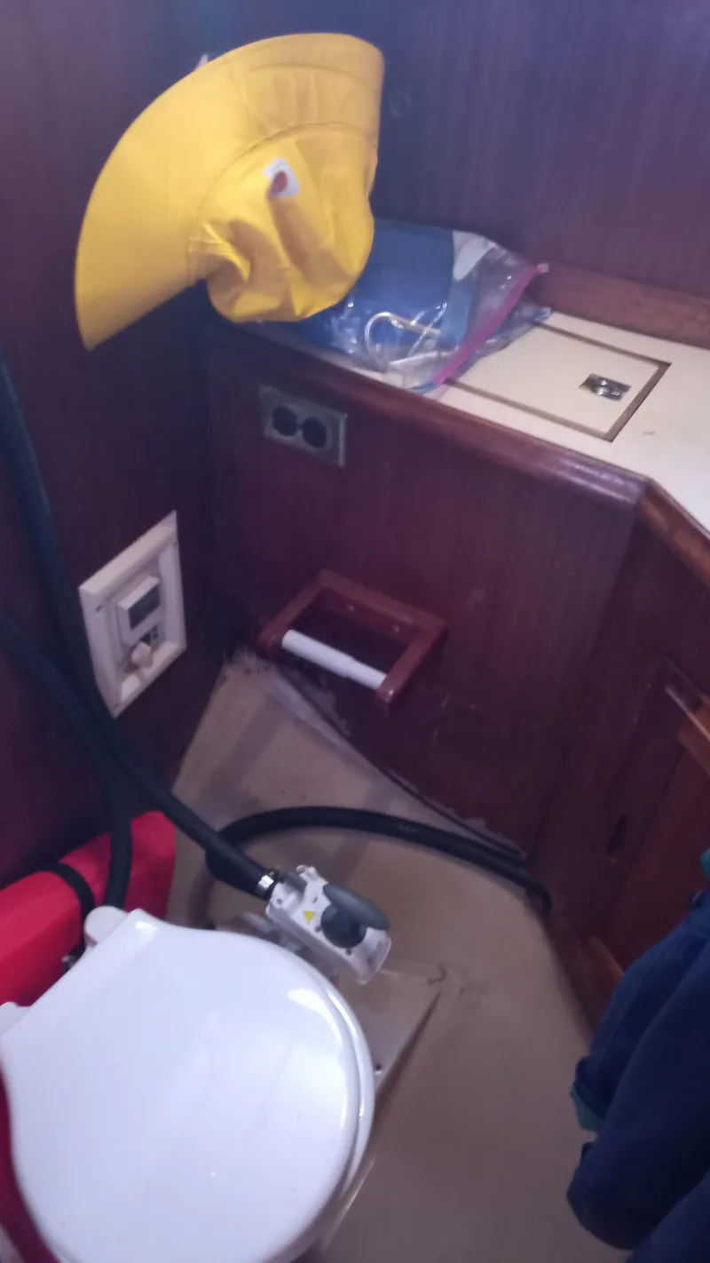Slide: The Image of Interior of a 1977 Ericson 31 yacht with toilet and yellow hat. - 12