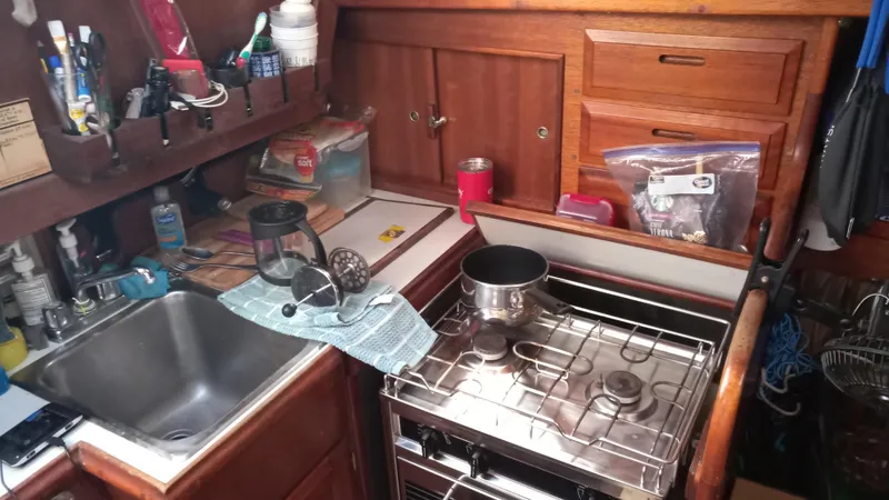 Slide: The Image of 1977 Ericson 31 yacht kitchen interior with stove and sink. - 14