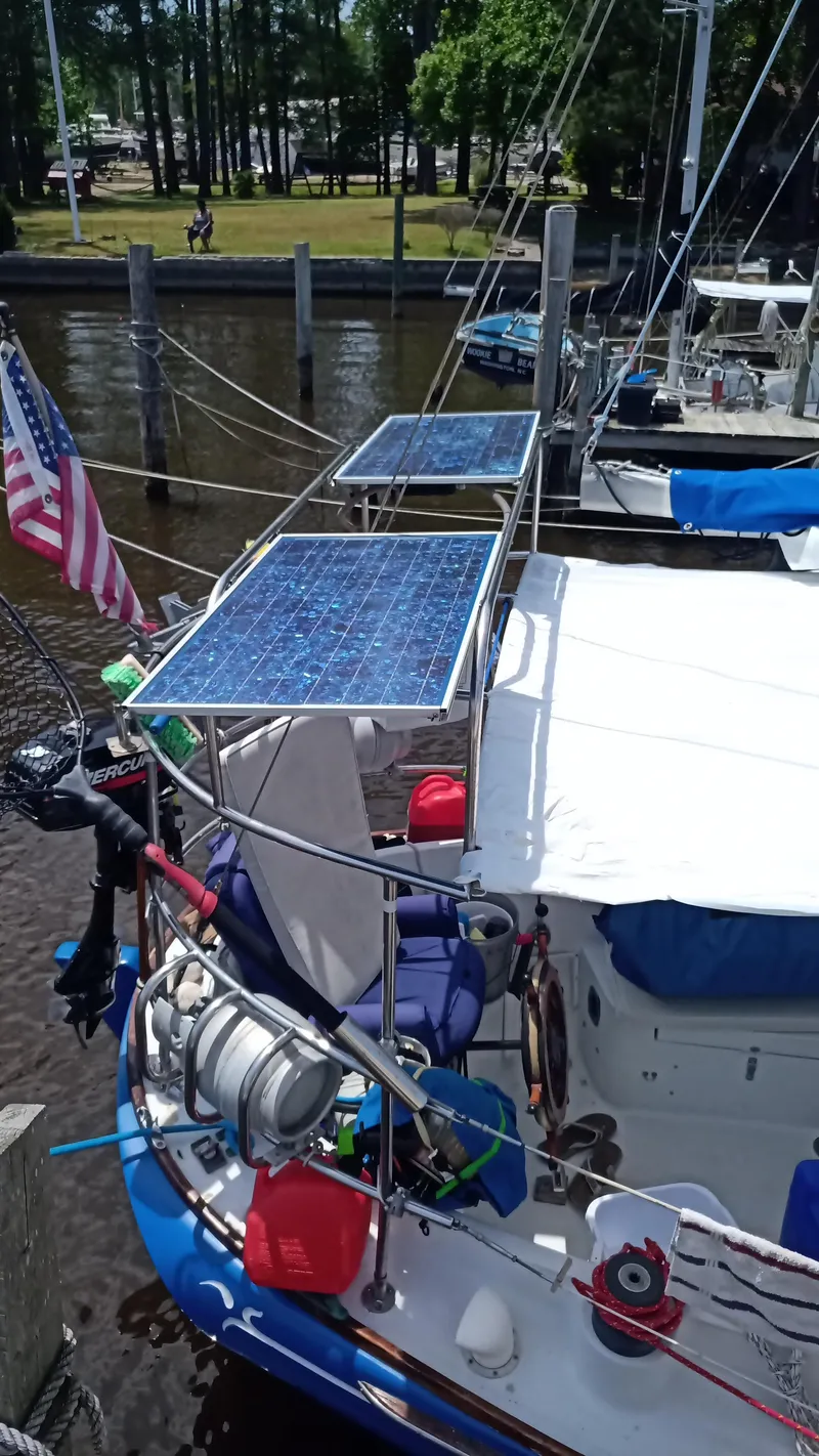 Slide: The Image of 1977 Ericson 31 sailboat with solar panels docked. - 15