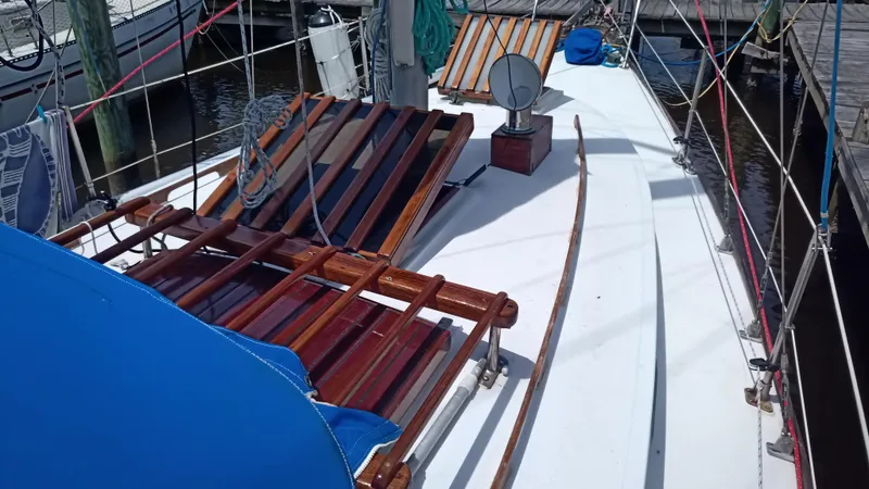 Slide: The Image of 1977 Ericson 31 sailboat with wooden deck and blue covers. - 19