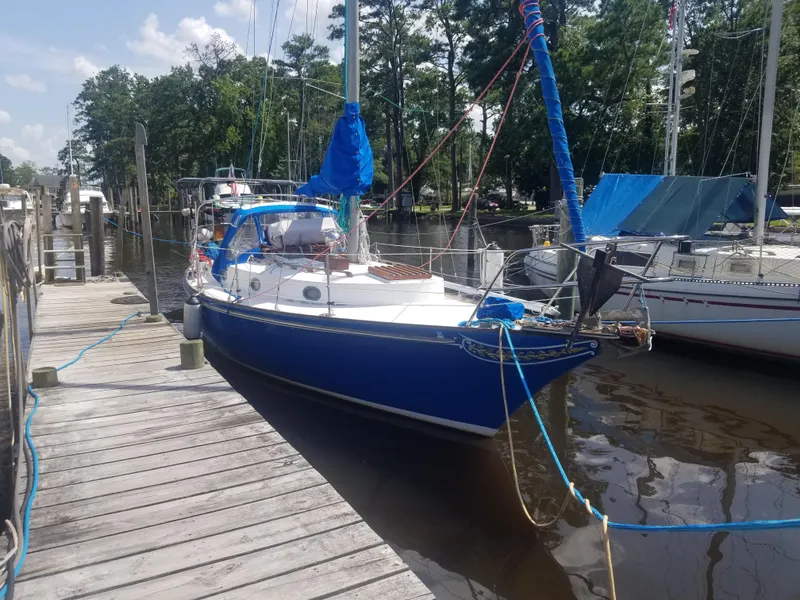 Slide: The Image of 1977 Ericson 31 sailboat docked, blue hull. - 2