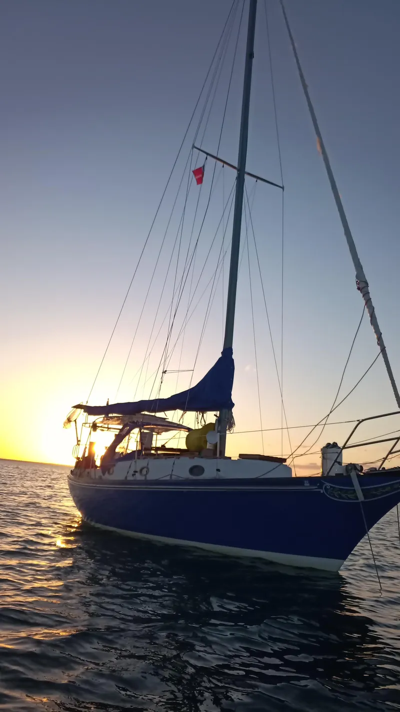 Slide: The Image of 1977 Ericson 31 sailboat on water at sunset. - 20