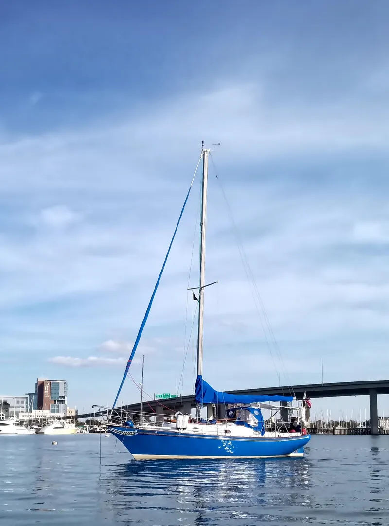 Slide: The Image of Blue 1977 Ericson 31 sailboat on calm water. - 21