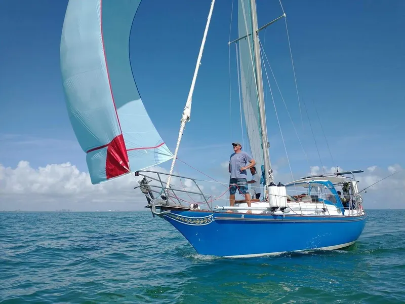 Slide: The Image of 1977 Ericson 31 sailboat on open sea under clear sky. - 4