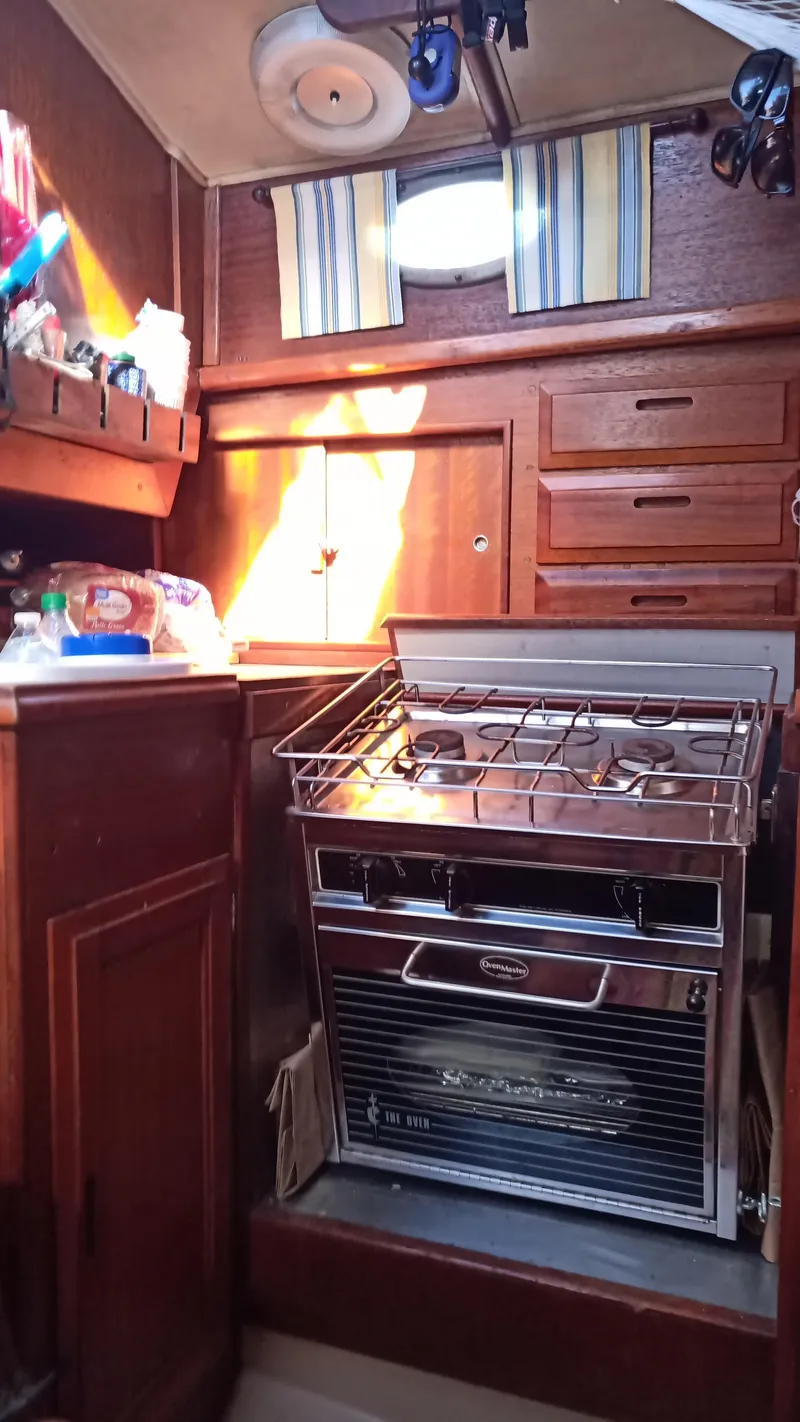 Slide: The Image of 1977 Ericson 31 yacht interior with stove and wooden cabinets. - 7