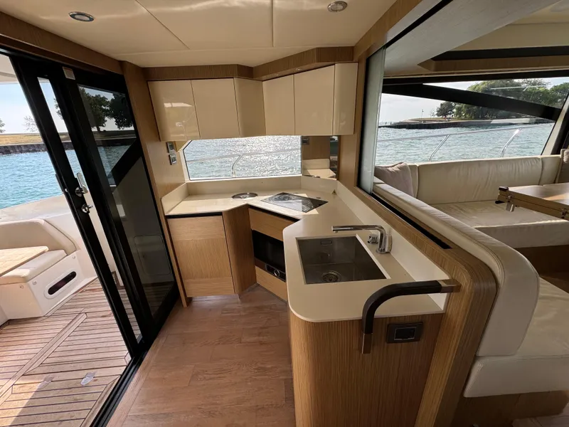 Slide: The Image of Luxurious interior of a 2017 Absolute 50 Fly yacht with modern kitchen and scenic water view. - 15