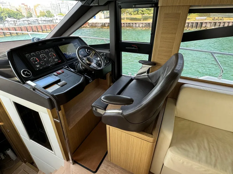 Slide: The Image of Luxurious helm of 2017 Absolute 50 Fly yacht with modern controls and leather seating. - 21