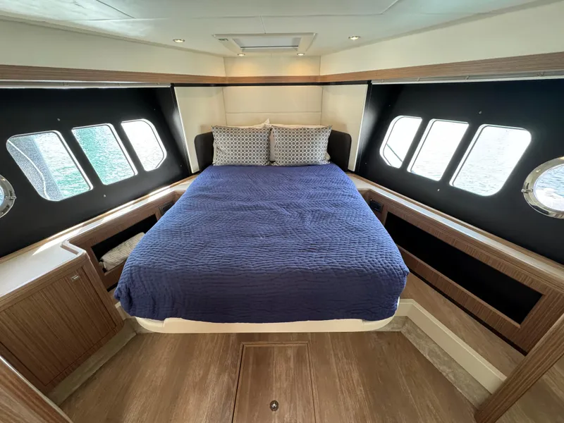 Slide: The Image of Luxurious bedroom interior of 2017 Absolute 50 Fly yacht with blue bedding and large windows. - 22