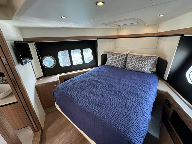 Slide: The Image of Luxurious cabin interior of 2017 Absolute 50 Fly yacht with cozy bed and porthole windows. - 23