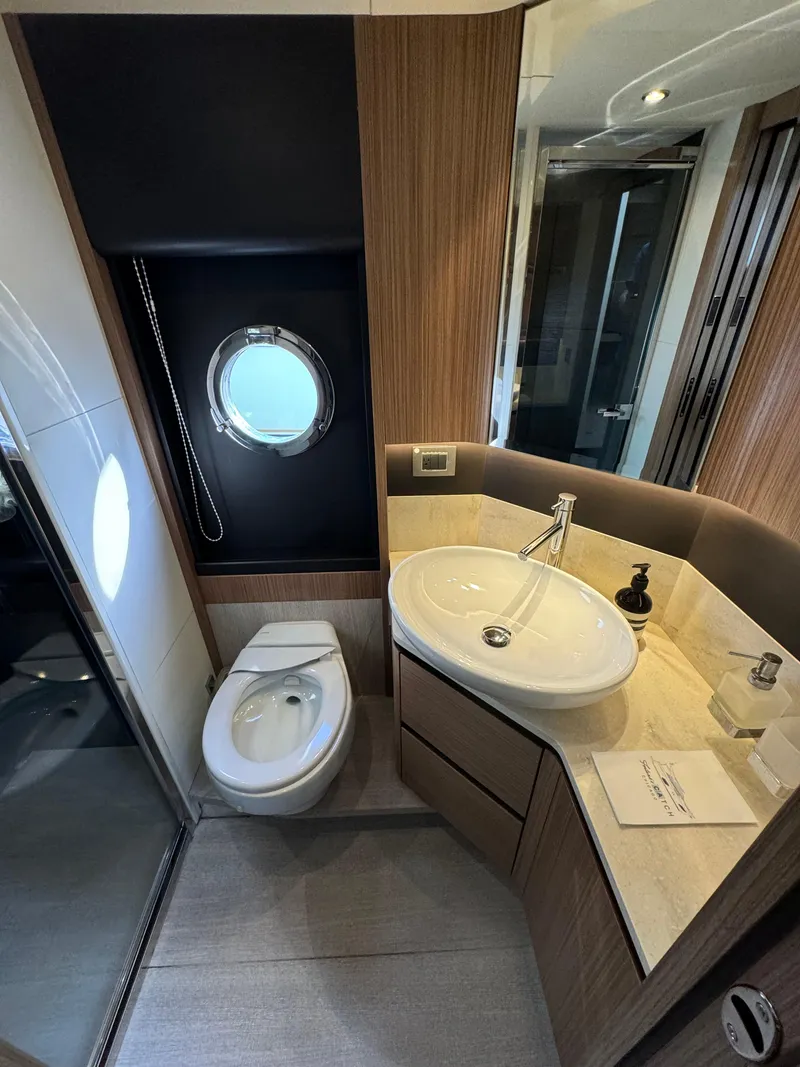 Slide: The Image of Luxurious bathroom in 2017 Absolute 50 Fly yacht with modern fixtures and porthole window. - 30