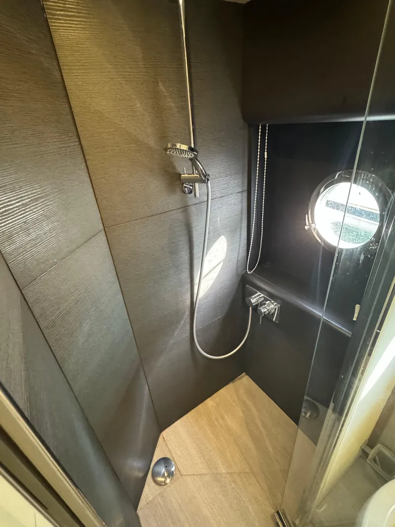 Slide: The Image of Luxurious shower in 2017 Absolute 50 Fly yacht with modern fixtures and porthole window. - 31