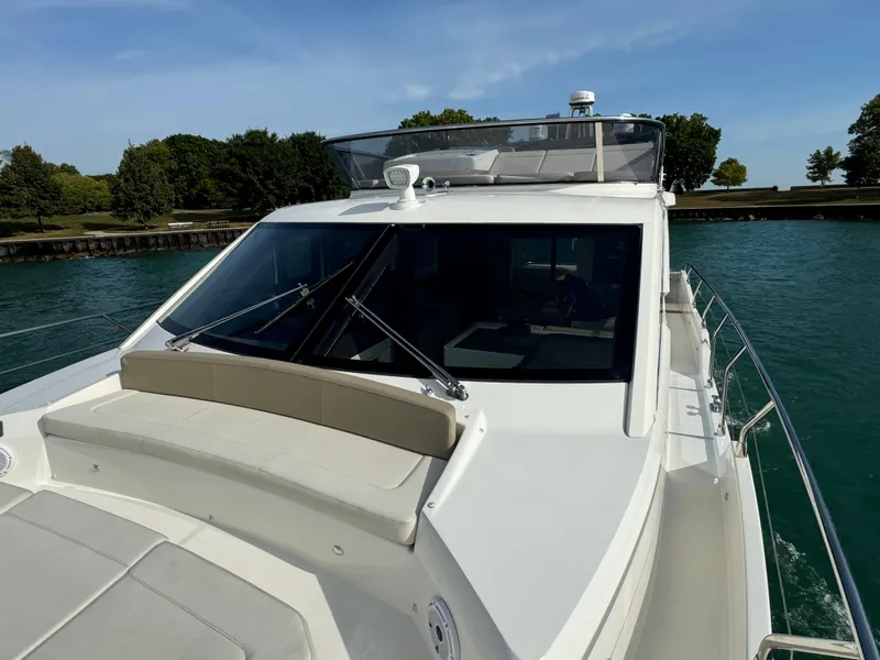 Slide: The Image of 2017 Absolute 50 Fly yacht on water, featuring sleek design and spacious deck. - 35
