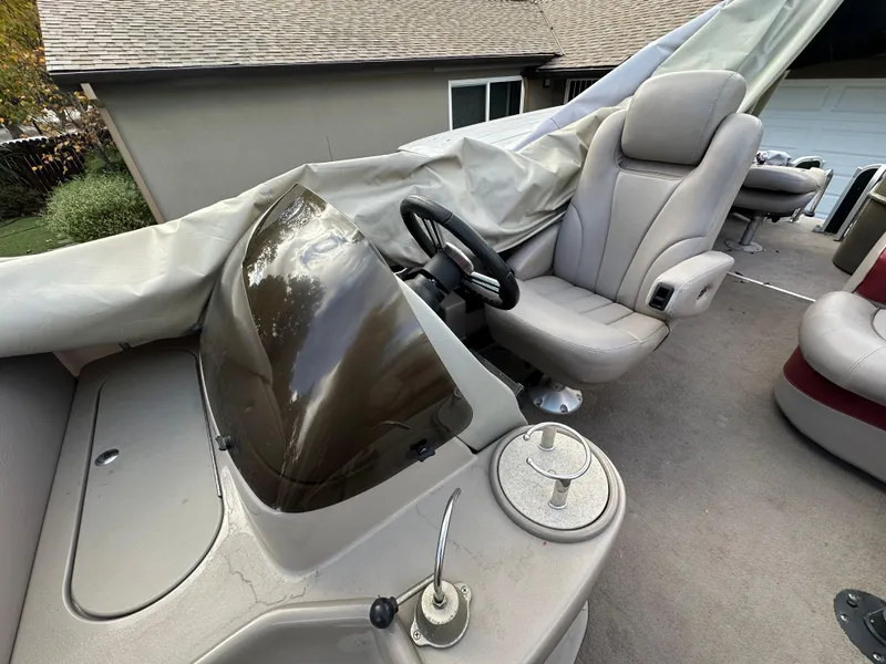 Slide: The Image of 2009 Premier 251 Castaway boat interior with steering console and covered seating. - 15