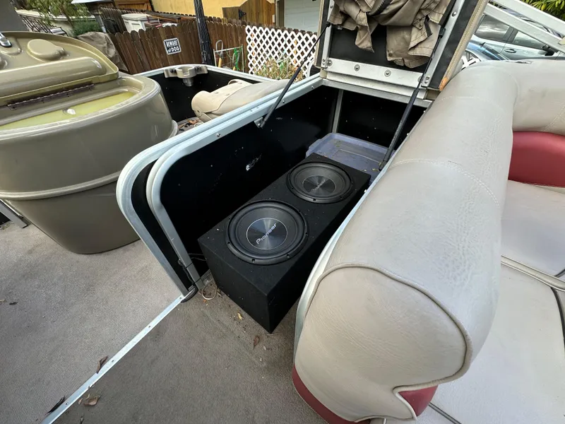 Slide: The Image of 2009 Premier 251 Castaway boat interior with subwoofers and seating. - 16