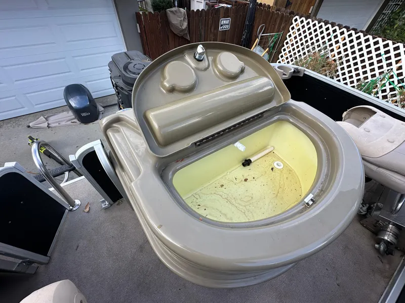 Slide: The Image of 2009 Premier 251 CASTAWAY boat livewell with open lid, showing interior details. - 17