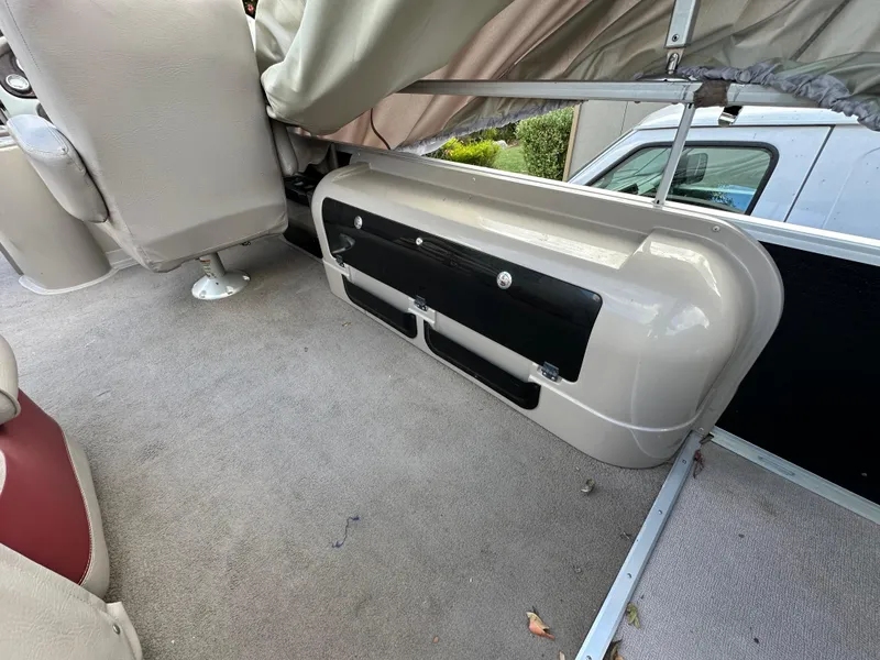 Slide: The Image of Interior of 2009 Premier 251 Castaway boat with beige seating and carpet. - 18