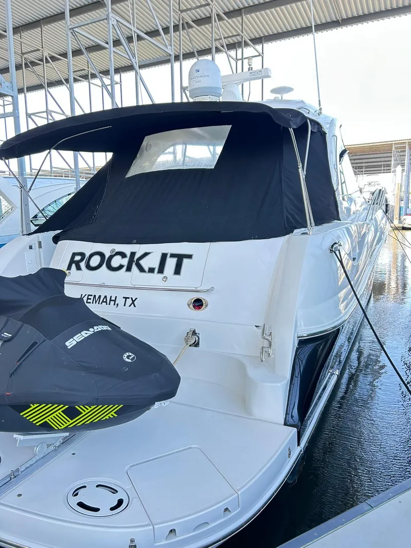 Slide: The Image of 2007 Sea Ray 52 Sundancer docked, featuring a black canopy and jet ski, labeled "ROCK.IT." - 14