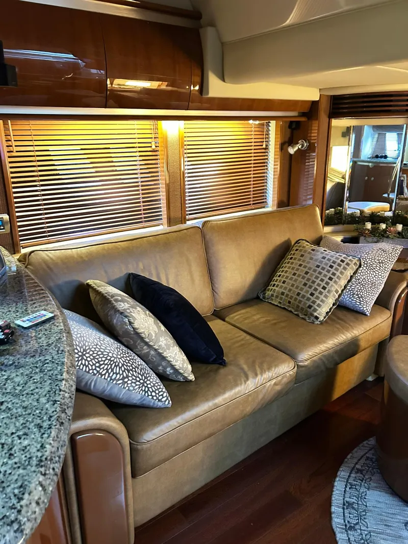 Slide: The Image of Luxurious interior of 2007 Sea Ray 52 Sundancer with leather sofa and decorative pillows. - 23