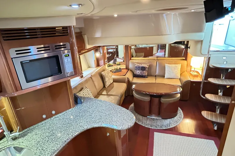Slide: The Image of Luxurious interior of 2007 Sea Ray 52 Sundancer yacht with modern kitchen and cozy seating area. - 24