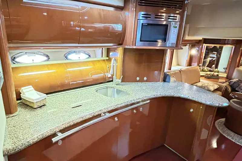 Slide: The Image of Luxurious 2007 Sea Ray 52 Sundancer yacht kitchen with granite countertops and modern appliances. - 26