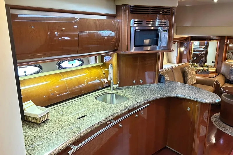 Slide: The Image of Luxurious 2007 Sea Ray 52 Sundancer yacht interior with modern kitchen and elegant wood finishes. - 27