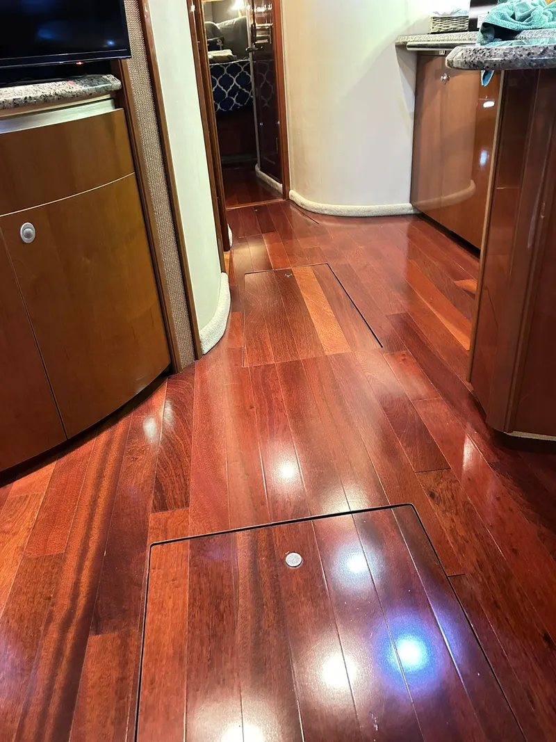 Slide: The Image of Luxurious interior of a 2007 Sea Ray 52 Sundancer with polished wooden flooring. - 28