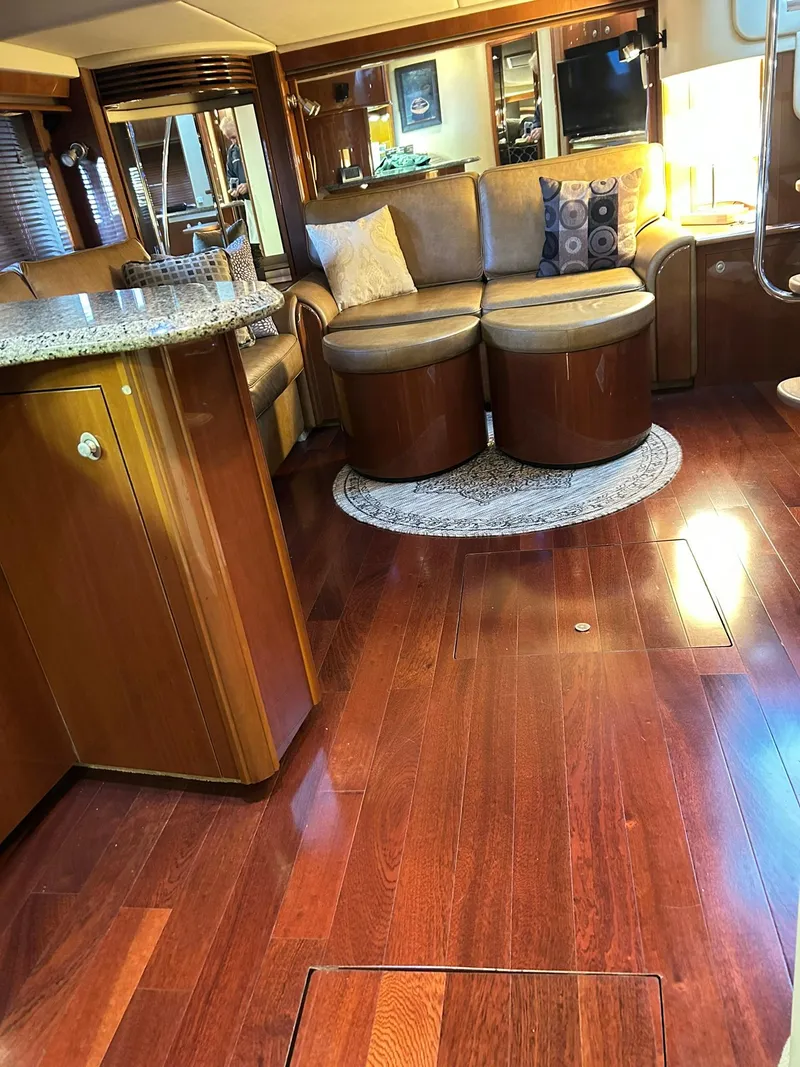 Slide: The Image of Luxurious interior of 2007 Sea Ray 52 Sundancer with polished wood flooring and elegant seating. - 29
