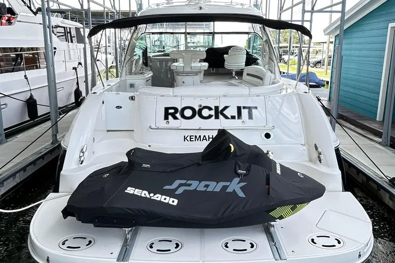 Slide: The Image of 2007 Sea Ray 52 Sundancer yacht with Sea-Doo Spark jet ski on deck, docked in marina. - 3