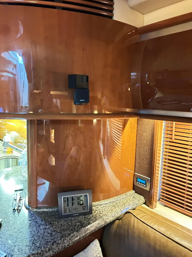 Slide: The Image of Interior of 2007 Sea Ray 52 Sundancer yacht with wood paneling and digital clock. - 30