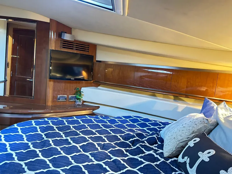 Slide: The Image of Luxurious cabin interior of 2007 Sea Ray 52 Sundancer yacht with cozy bedding and TV. - 34