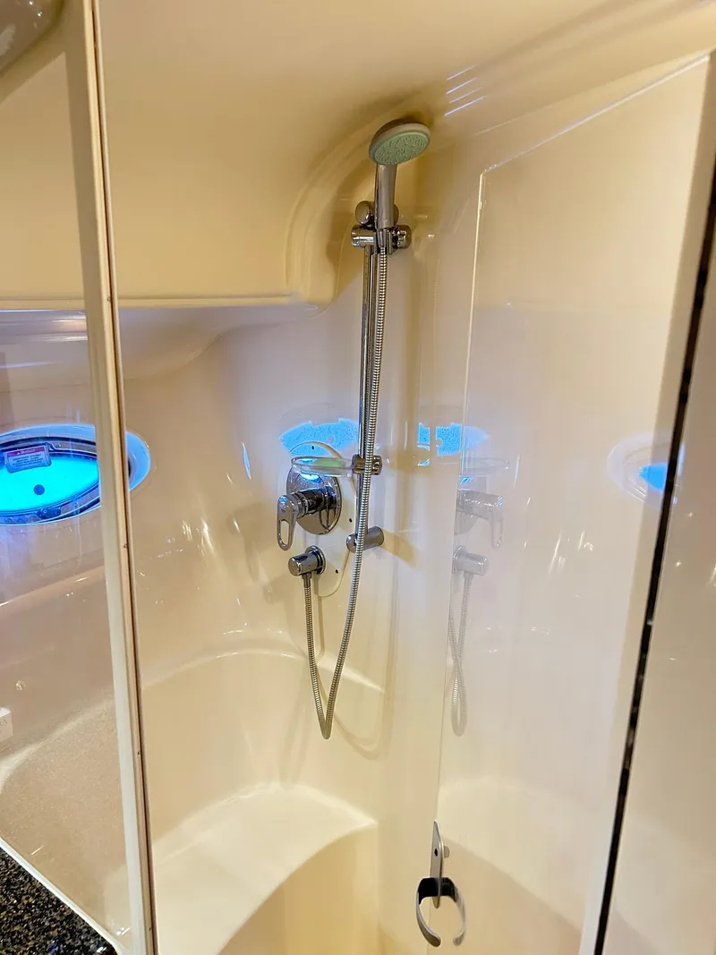 Slide: The Image of Shower area in 2007 Sea Ray 52 Sundancer yacht with modern fixtures and porthole windows. - 37