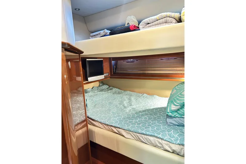 Slide: The Image of Interior cabin of 2007 Sea Ray 52 Sundancer with cozy bedding and TV. - 39