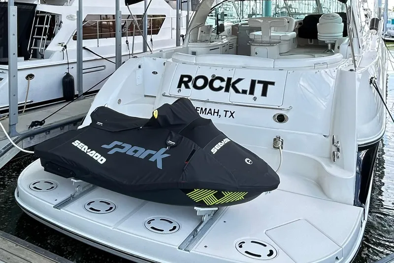 Slide: The Image of 2007 Sea Ray 52 Sundancer yacht with Sea-Doo Spark jet ski on the deck, docked in Kemah, TX. - 4