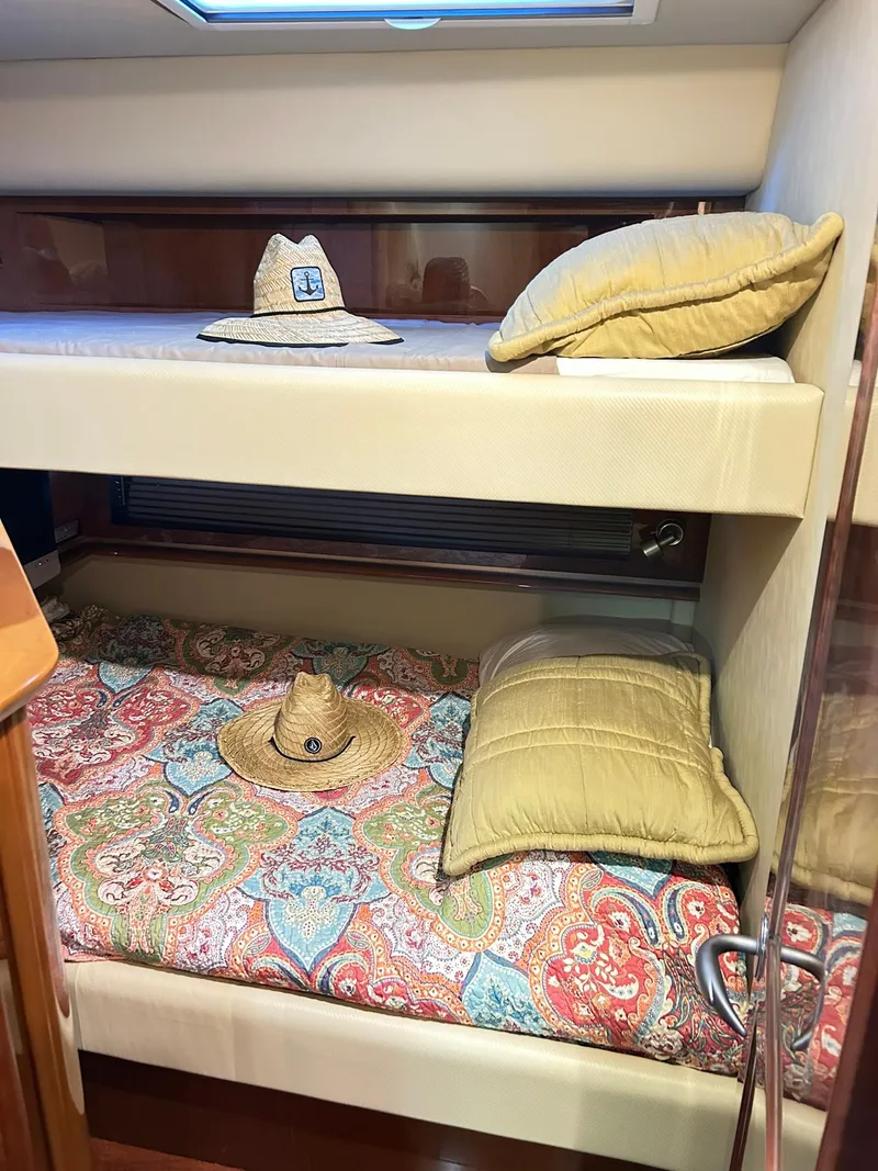 Slide: The Image of 2007 Sea Ray 52 Sundancer cabin with bunk beds and decorative pillows. - 40