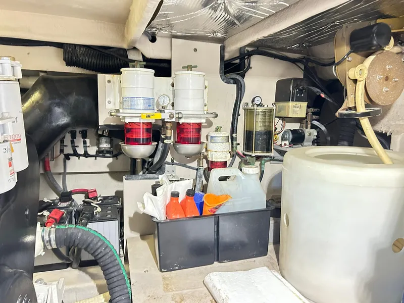 Slide: The Image of Engine room of a 2007 Sea Ray 52 Sundancer with various mechanical components and storage containers. - 44