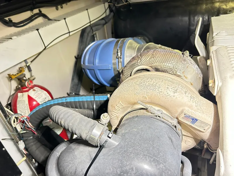 Slide: The Image of Engine compartment of a 2007 Sea Ray 52 Sundancer with visible turbocharger and fire extinguisher. - 49