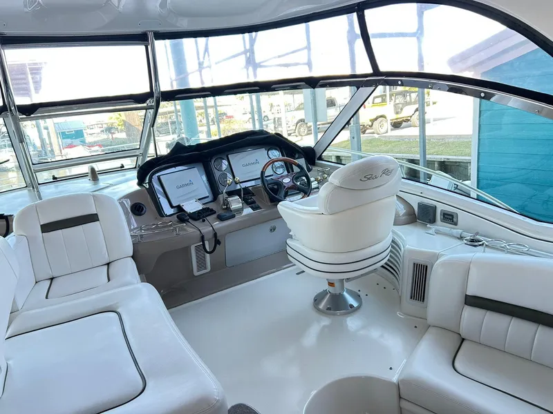 Slide: The Image of 2007 Sea Ray 52 Sundancer yacht cockpit with white seating and modern navigation equipment. - 54