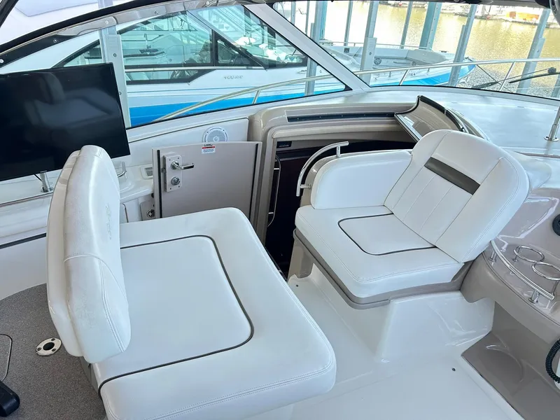 Slide: The Image of 2007 Sea Ray 52 Sundancer cockpit with white seating and modern controls. - 55