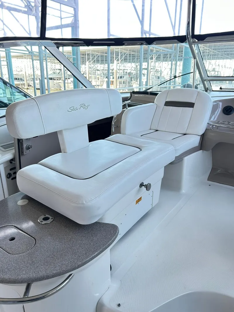 Slide: The Image of 2007 Sea Ray 52 Sundancer yacht interior with white seating and helm station. - 56