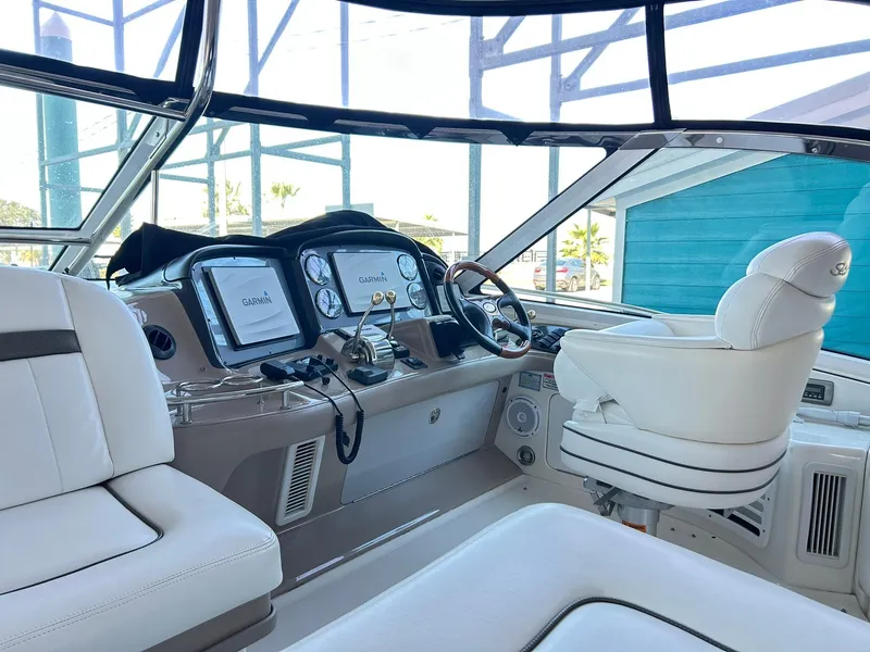 Slide: The Image of Helm of 2007 Sea Ray 52 Sundancer with modern navigation equipment and plush seating. - 57