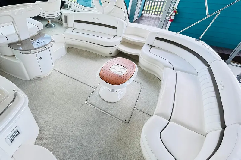 Slide: The Image of Luxurious 2007 Sea Ray 52 Sundancer yacht interior with elegant white seating and wooden table. - 80