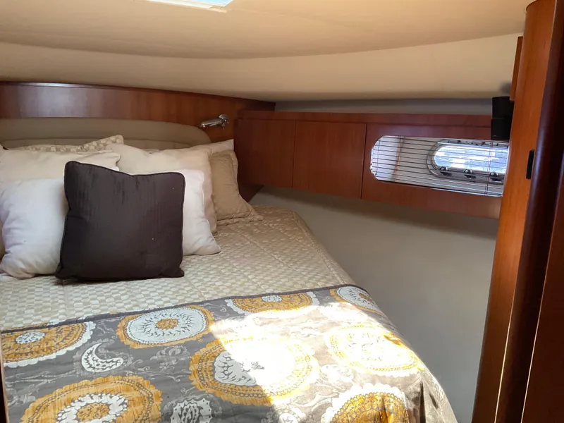 Slide: The Image of Cozy cabin interior of 2004 Tiara Yachts 4400 Sovran with bed and window. - 10